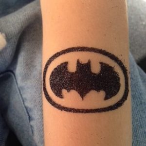 batman symbol tattoo on wrist